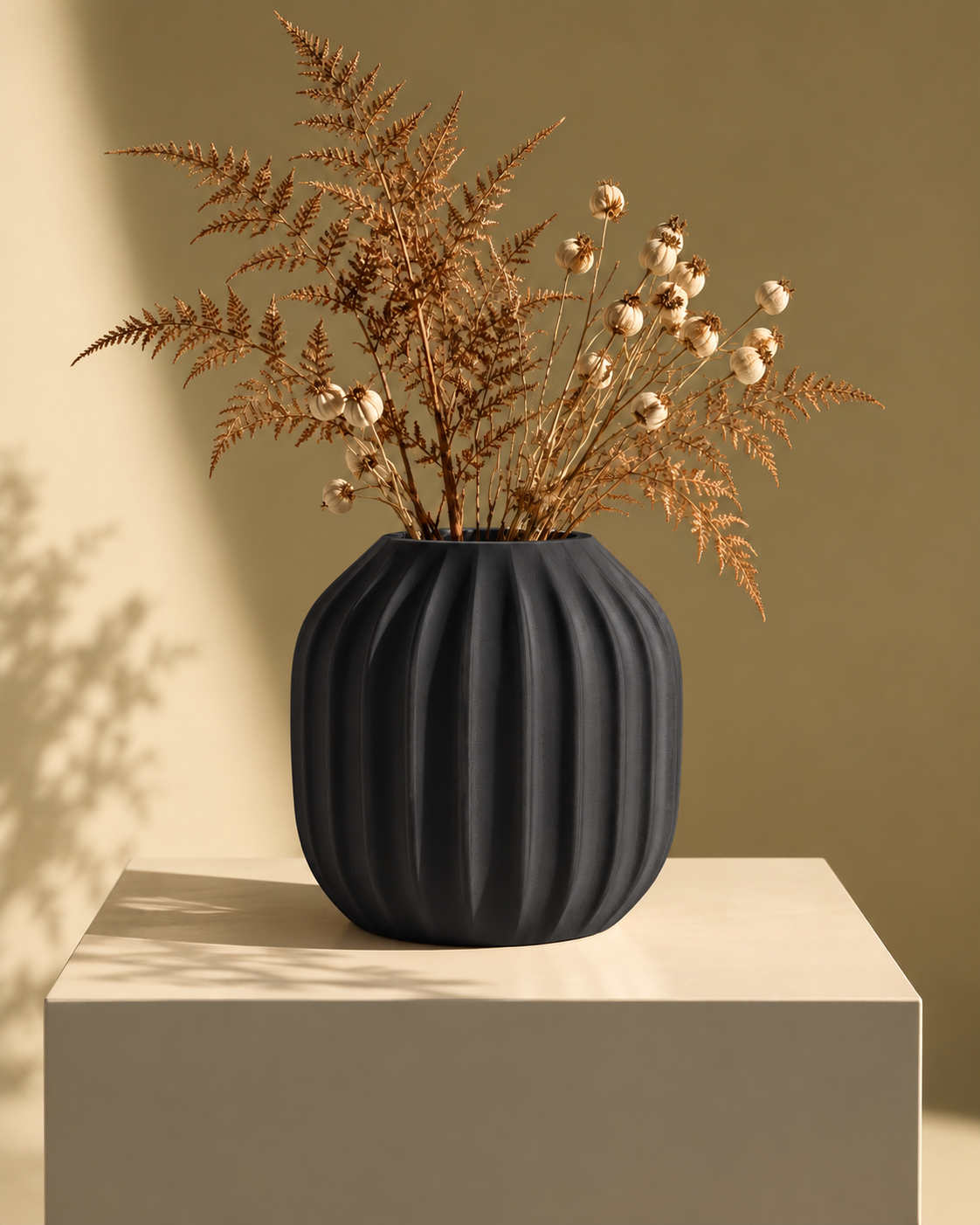 Marama round pleated vase in Charcoal, with dried stems, warm minimal pedestal, LAYR, made in New Zealand