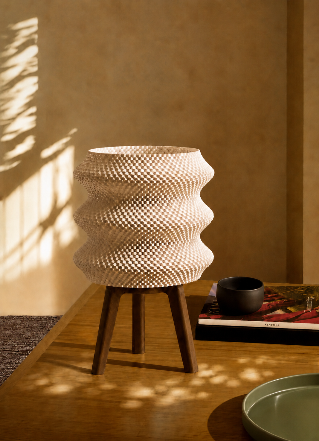 Ngaru table lamp in warm sunlight casting a soft shadow on a coffee table, LAYR, made in New Zealand