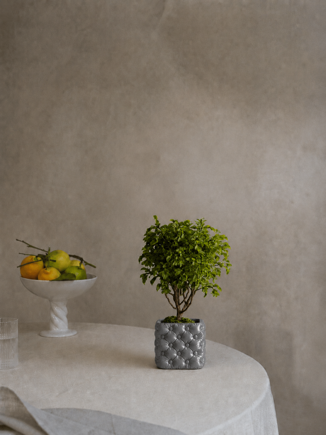 Hono tufted planter in Silk Grey, on a table, LAYR, made in New Zealand
