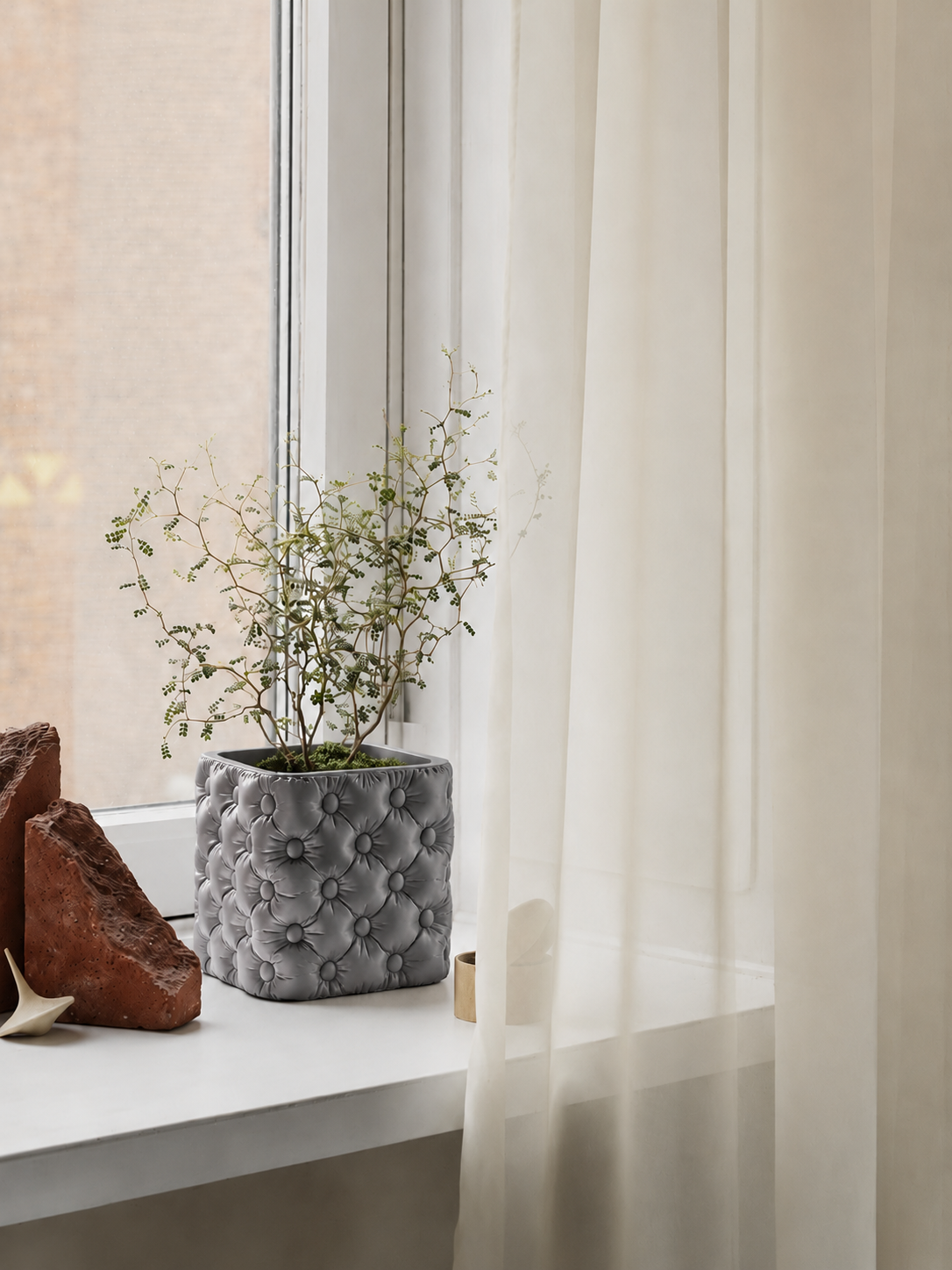 Hono tufted planter in Silk Grey, on a windowsill, LAYR, made in New Zealand