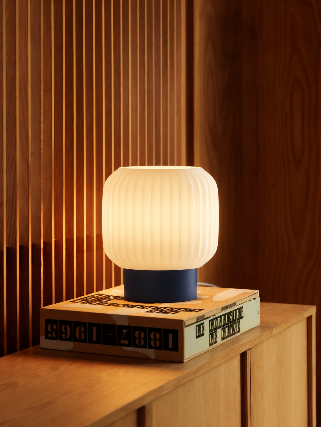 Marama pleated table lamp, white shade with Blue base, books on oak, LAYR, made in New Zealand